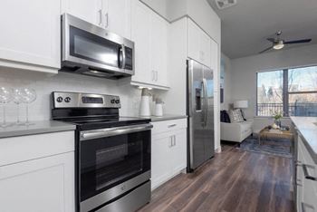 a kitchen with stainless steel appliances and white cabinets